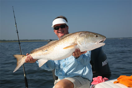 SWEET REVENGE!  The author shows off a huge red drum after returning to North Carolina, where he accidentally severed his wrist during a "blown out" show a year earlier.