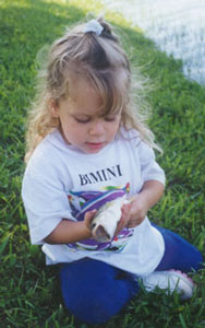 Megan Poveromo with a largemouth bass prior to releasing it in a lake by her home in 1998.
